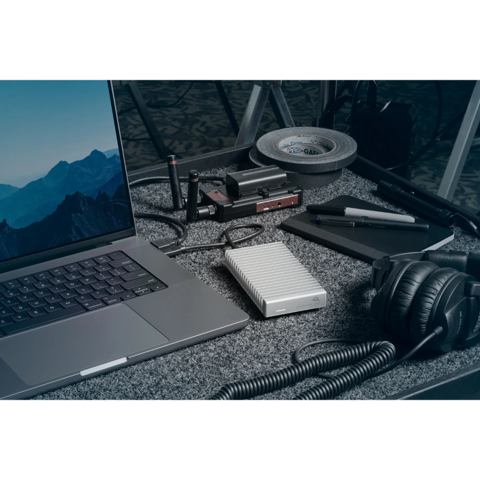 OWC Express 1M2 80G external SSD drive attached to a laptop in a professional environment for set on the go
